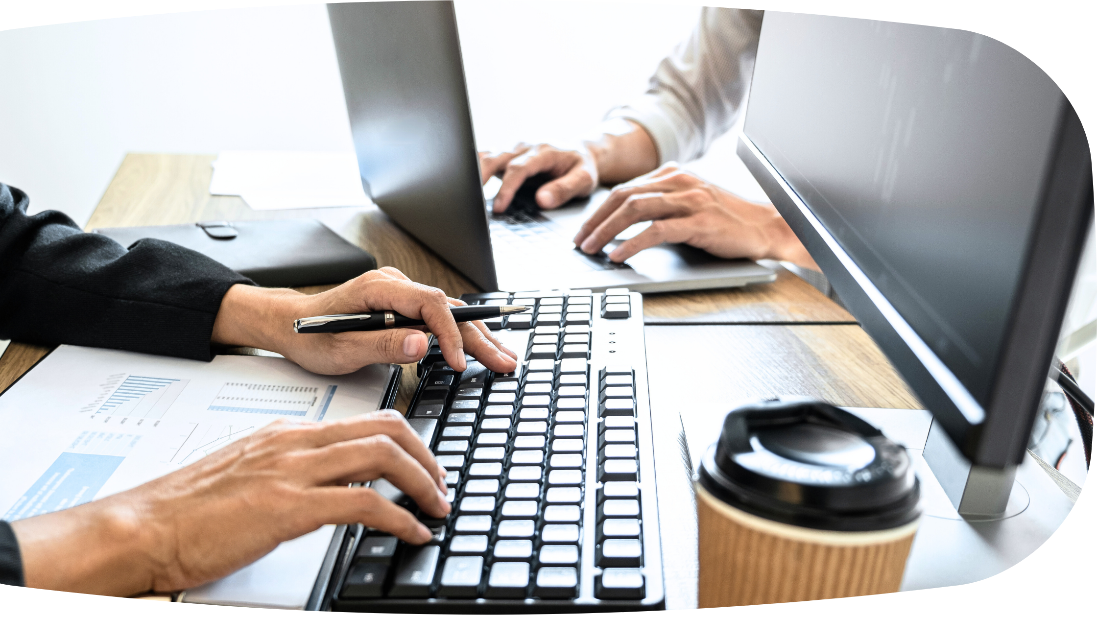 two people typing on keyboards. We only see their hands